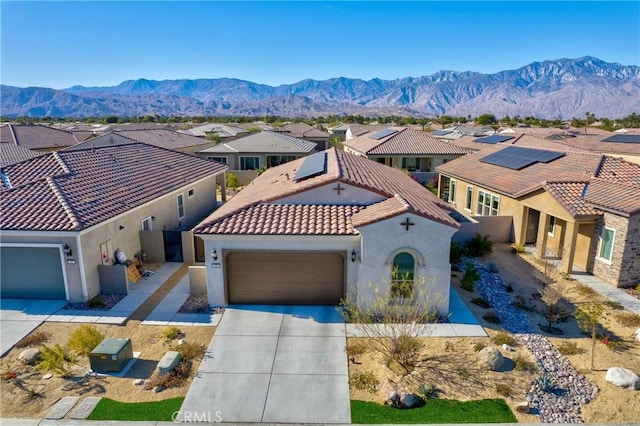 48 Vintage, Rancho Mirage, CA 92270 - mediterranean / spanish-style home featuring a residential view, a tile roof, an attached garage, stucco siding, and concrete driveway