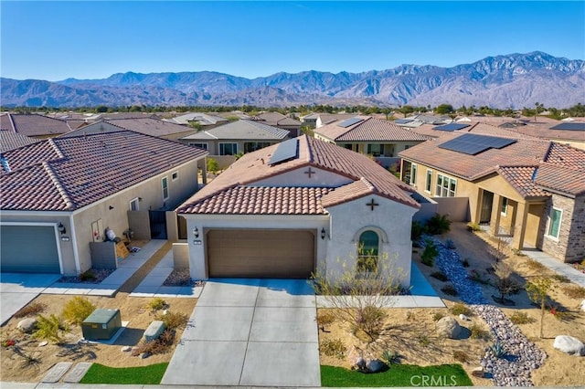 48 Vintage, Rancho Mirage, CA 92270 - mediterranean / spanish-style house with a residential view, a tiled roof, an attached garage, stucco siding, and driveway