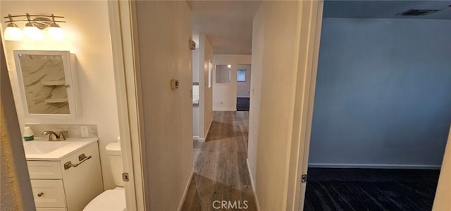 bathroom featuring hardwood / wood-style flooring, vanity, and toilet