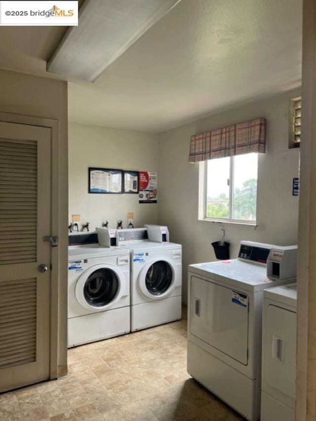 washroom with washing machine and clothes dryer