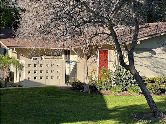 view of side of property with a lawn