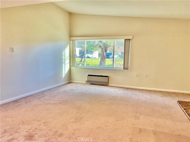 unfurnished living room featuring heating unit, lofted ceiling, and carpet flooring