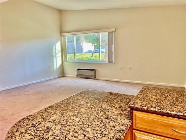 carpeted spare room with lofted ceiling