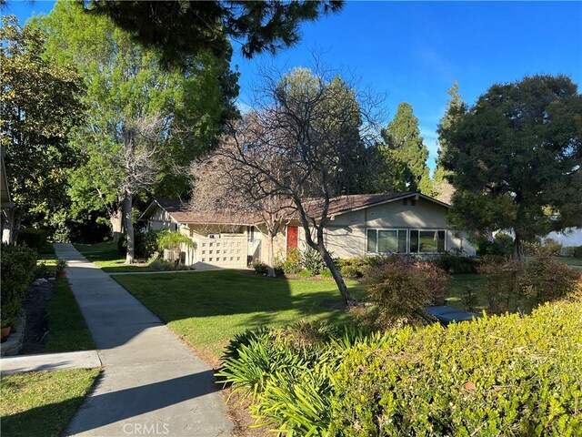 241 Calle Aragon Unit B, Laguna Woods, CA 92637 - view of front of home featuring a front lawn and stucco siding