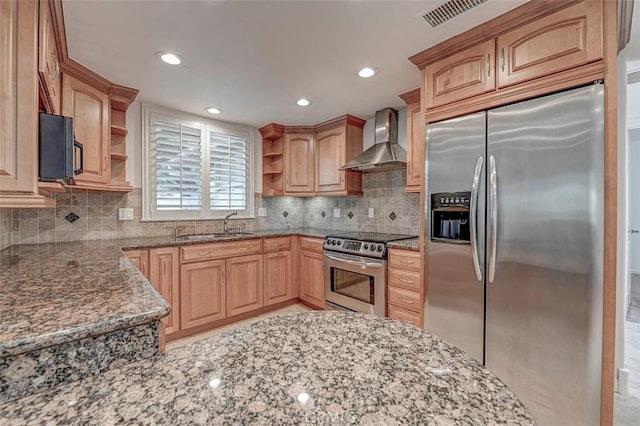 kitchen with stainless steel appliances, open shelves, wall chimney exhaust hood, stone countertops, and recessed lighting