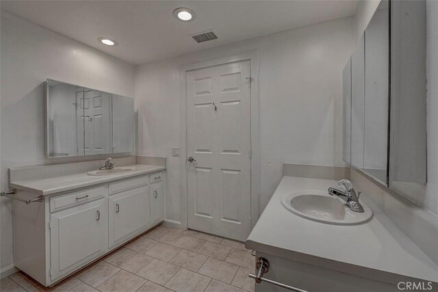 241 Calle Aragon Unit B, Laguna Woods, CA 92637 - full bathroom with tile patterned flooring, two vanities, recessed lighting, and baseboards