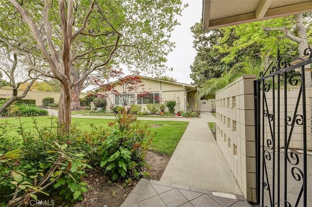 241 Calle Aragon Unit B, Laguna Woods, CA 92637 - view of yard with a gate and fence