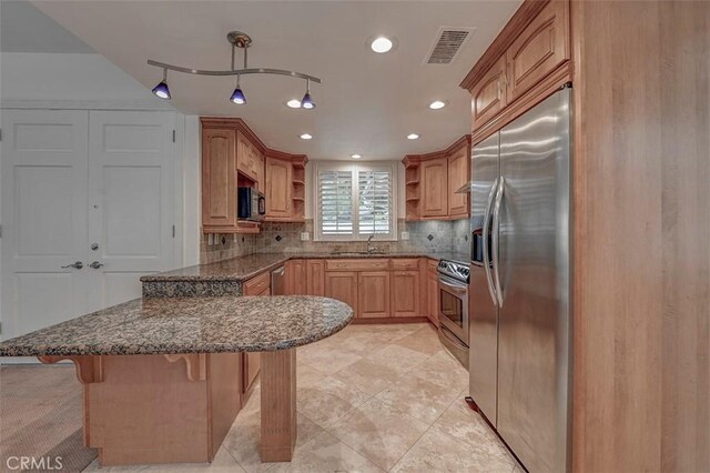 241 Calle Aragon Unit B, Laguna Woods, CA 92637 - kitchen featuring open shelves, stainless steel appliances, a peninsula, a sink, and dark stone countertops