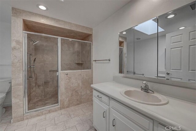 241 Calle Aragon Unit B, Laguna Woods, CA 92637 - bathroom with toilet, a stall shower, vanity, tile patterned floors, and recessed lighting