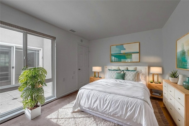 bedroom featuring access to outside and carpet flooring