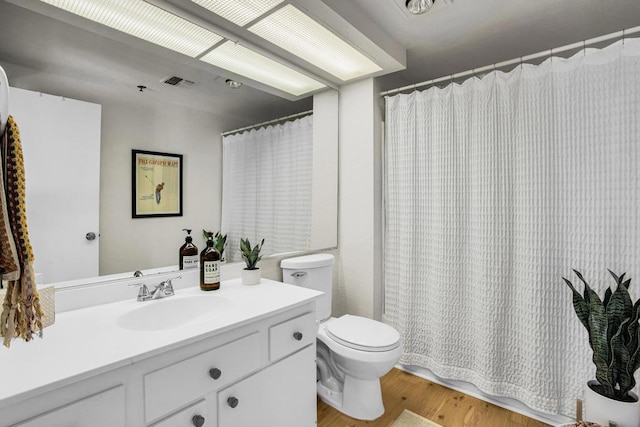 bathroom featuring vanity, a shower with curtain, wood-type flooring, and toilet