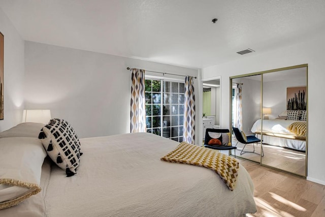 bedroom featuring light hardwood / wood-style floors and a closet