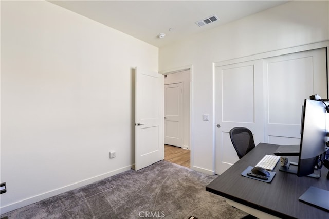 unfurnished office with dark colored carpet