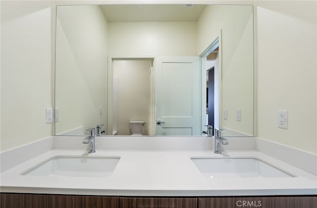 bathroom featuring vanity and toilet