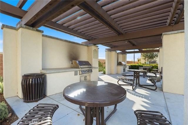 view of patio / terrace with an outdoor kitchen, grilling area, and a pergola