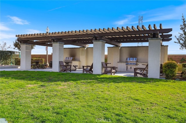 exterior space featuring exterior kitchen, a yard, a pergola, and a patio