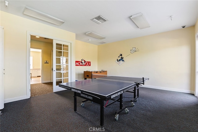 recreation room featuring dark carpet and french doors