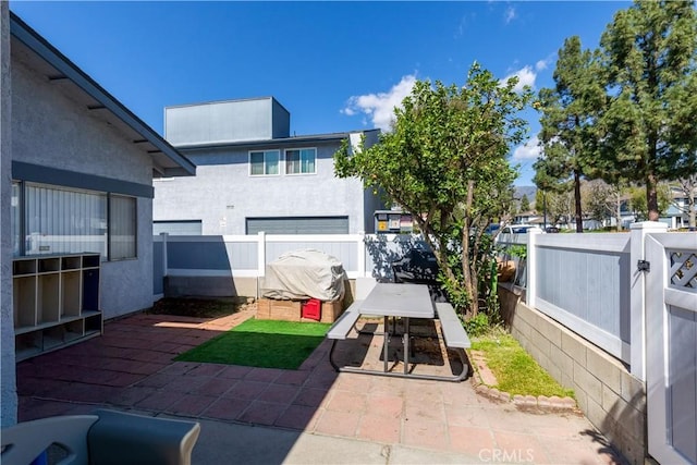 view of patio featuring a fenced backyard and outdoor dining area