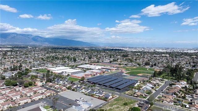 drone / aerial view featuring a residential view and a mountain view