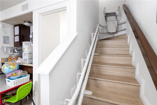 staircase featuring visible vents