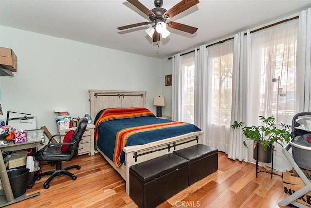 bedroom with ceiling fan and light hardwood / wood-style floors