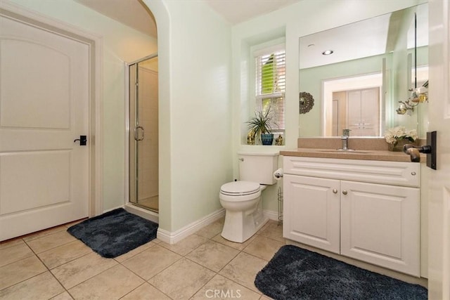 bathroom featuring an enclosed shower, vanity, tile patterned flooring, and toilet