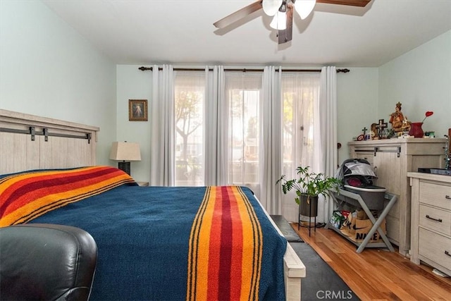 bedroom with ceiling fan and light wood-type flooring