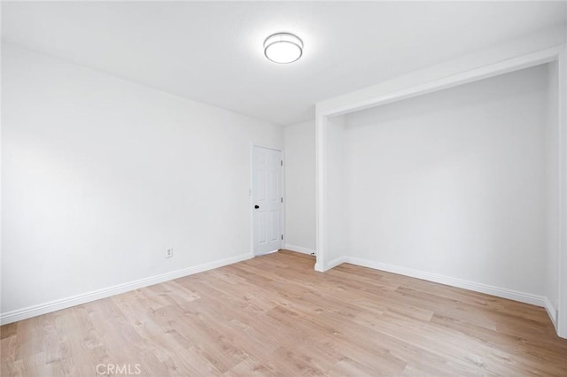 spare room featuring light hardwood / wood-style flooring