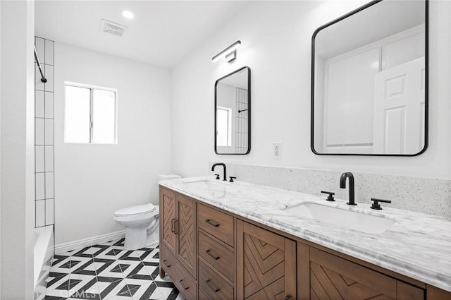 full bathroom with vanity, toilet, and  shower combination