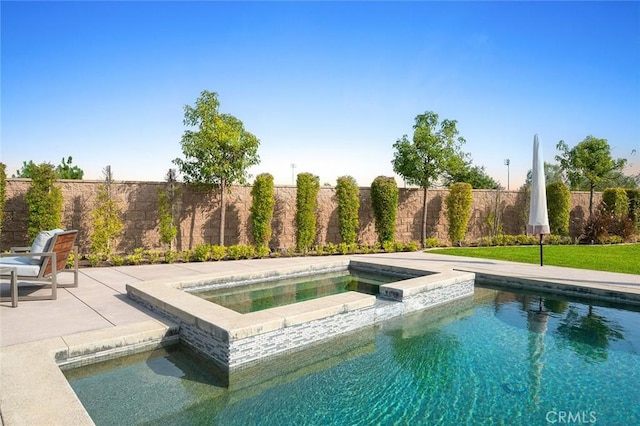 view of swimming pool featuring an in ground hot tub and a patio