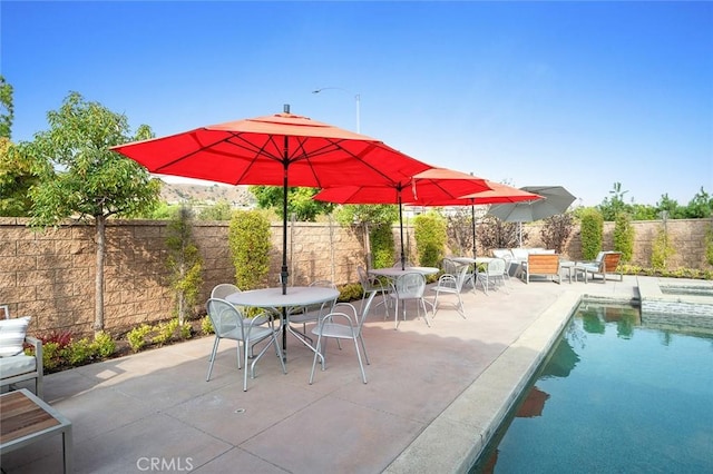 view of patio / terrace featuring a fenced in pool