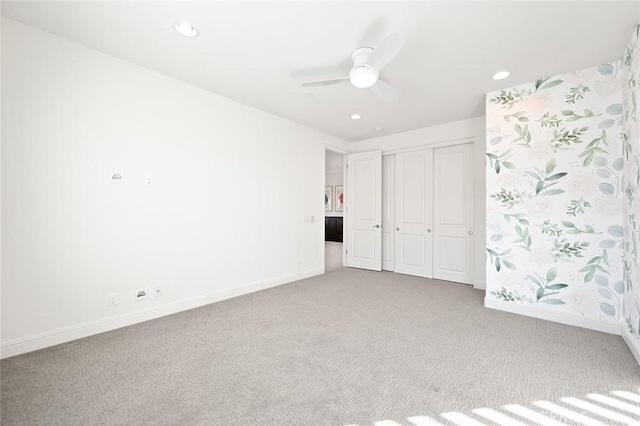 unfurnished bedroom with a closet, ceiling fan, and carpet flooring