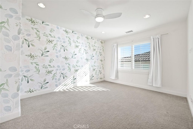 empty room featuring ceiling fan and carpet flooring