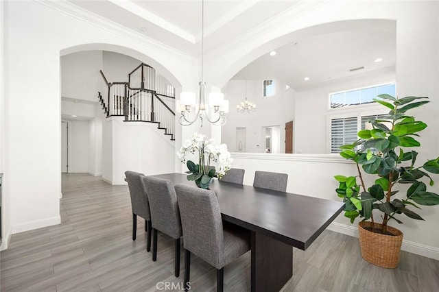 dining area with hardwood / wood-style floors and a chandelier