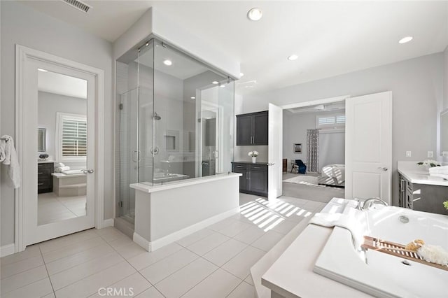 bathroom featuring vanity, shower with separate bathtub, and tile patterned floors