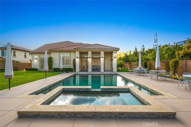 view of pool featuring an in ground hot tub, a yard, and a patio