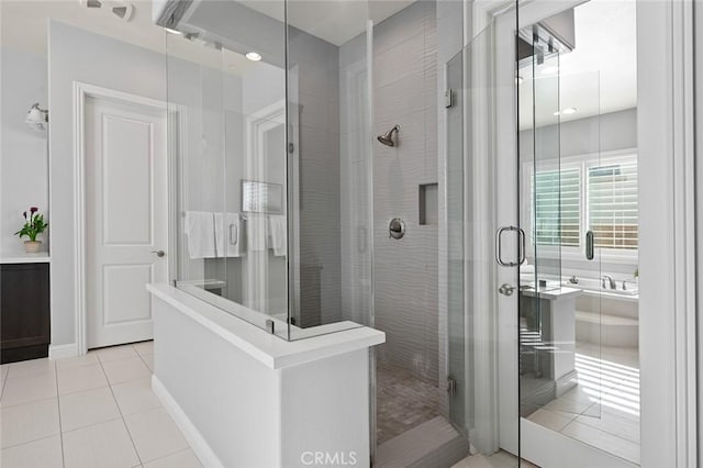 bathroom with an enclosed shower and tile patterned floors