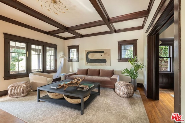 living room featuring coffered ceiling, beam ceiling, and light wood-type flooring