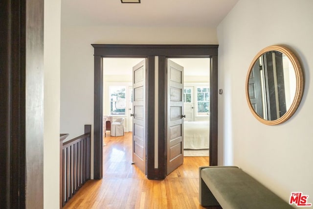 hallway with light hardwood / wood-style flooring