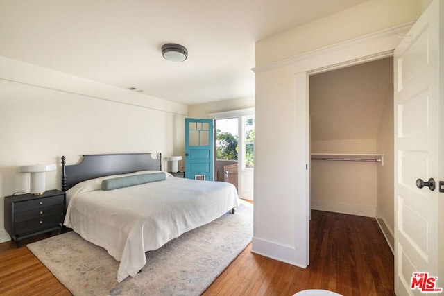 bedroom with hardwood / wood-style floors