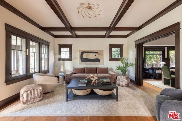 living room with beamed ceiling, coffered ceiling, and light wood-type flooring