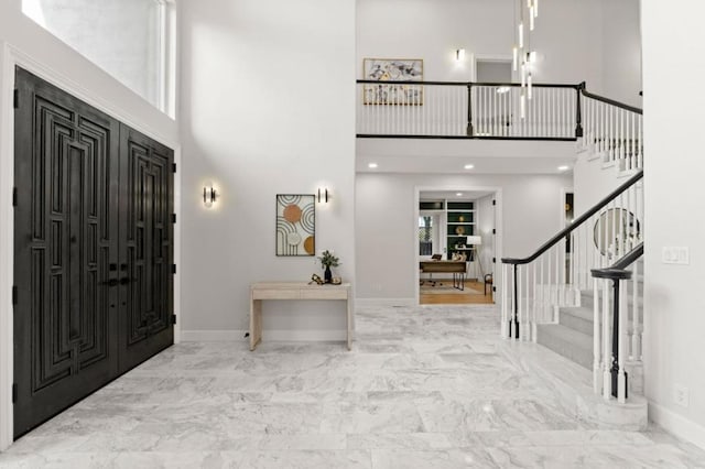 foyer entrance with a towering ceiling