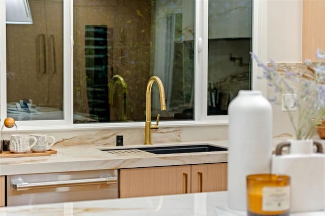 room details with light brown cabinetry and sink