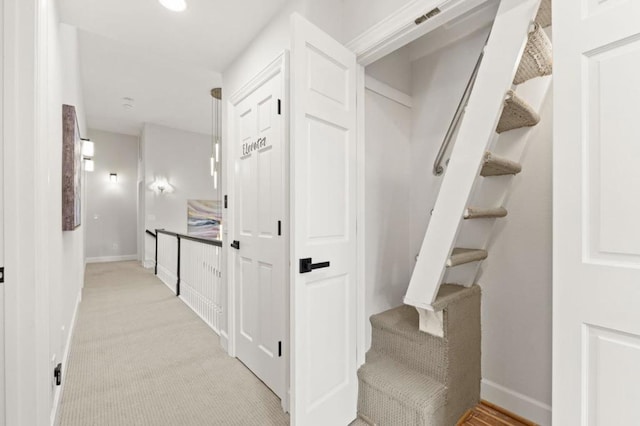 hall featuring light colored carpet