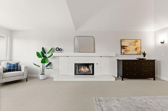 living room with vaulted ceiling and light colored carpet