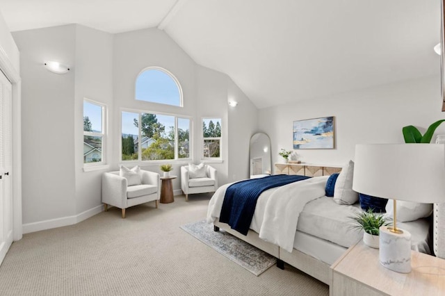 bedroom with high vaulted ceiling and light colored carpet