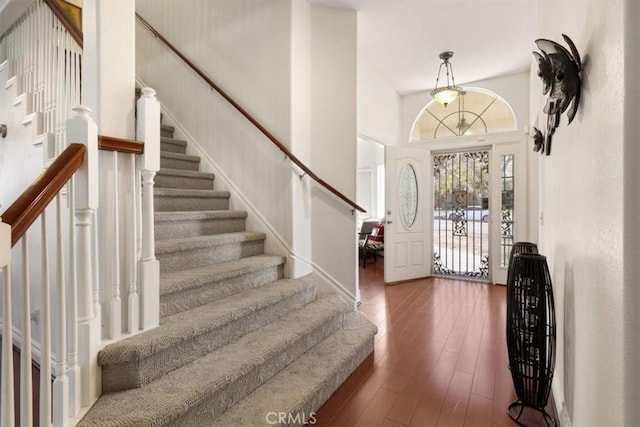 entryway with wood-type flooring and stairs