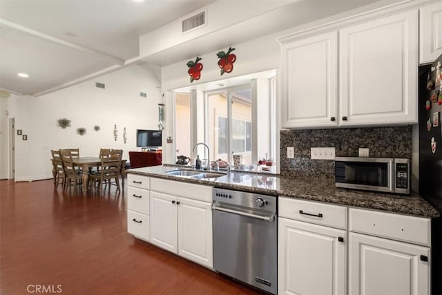 kitchen with visible vents, appliances with stainless steel finishes, white cabinets, and a sink