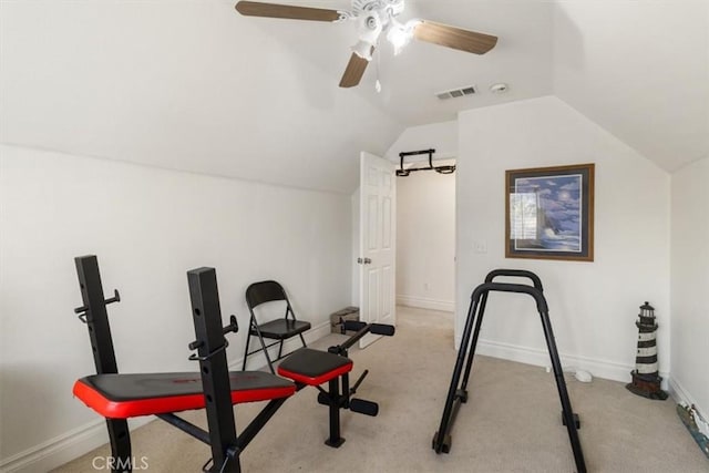 exercise room with lofted ceiling, baseboards, visible vents, and light colored carpet