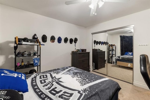 carpeted bedroom featuring ceiling fan and a closet